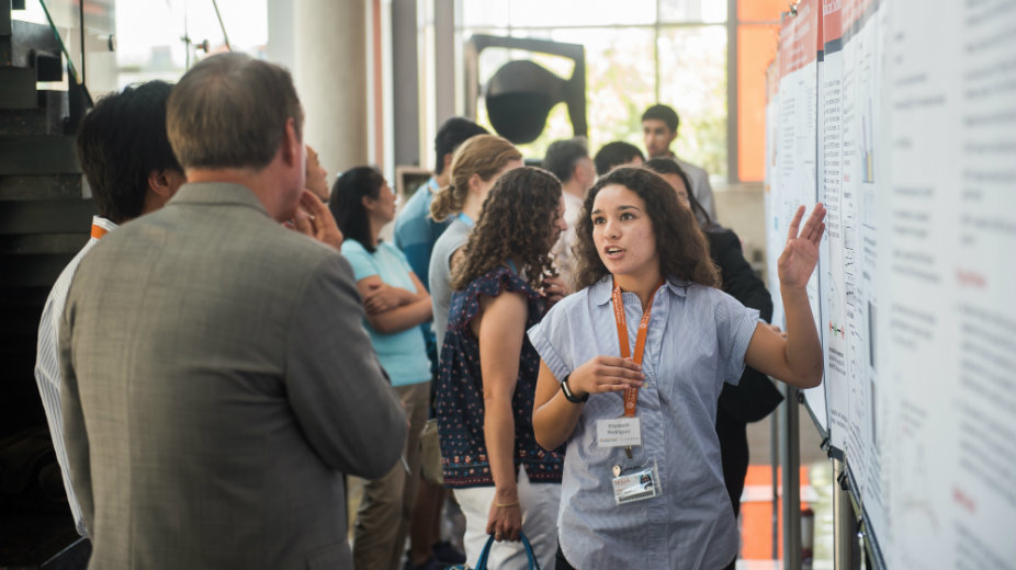 Woman speaking to colleagues.