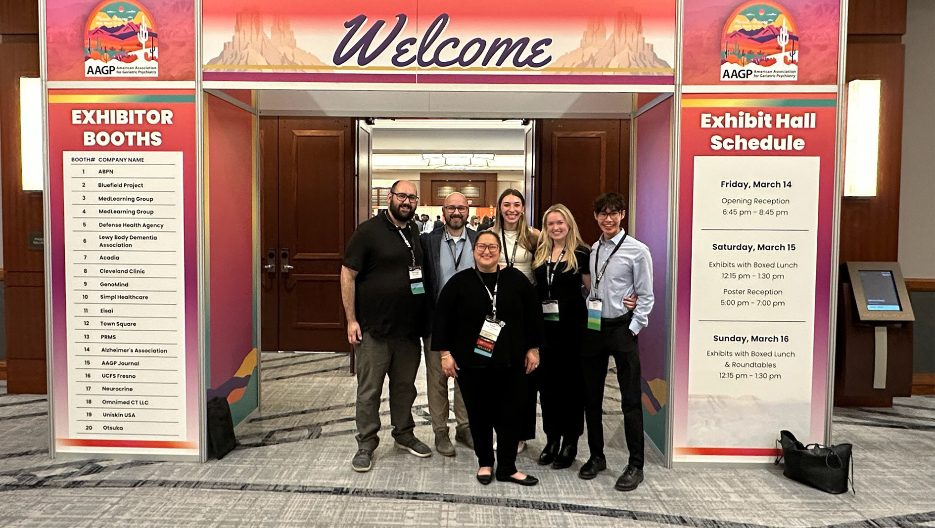Members of the Geriatric Psychiatry Fellowship stand by a welcome sign at a conference.