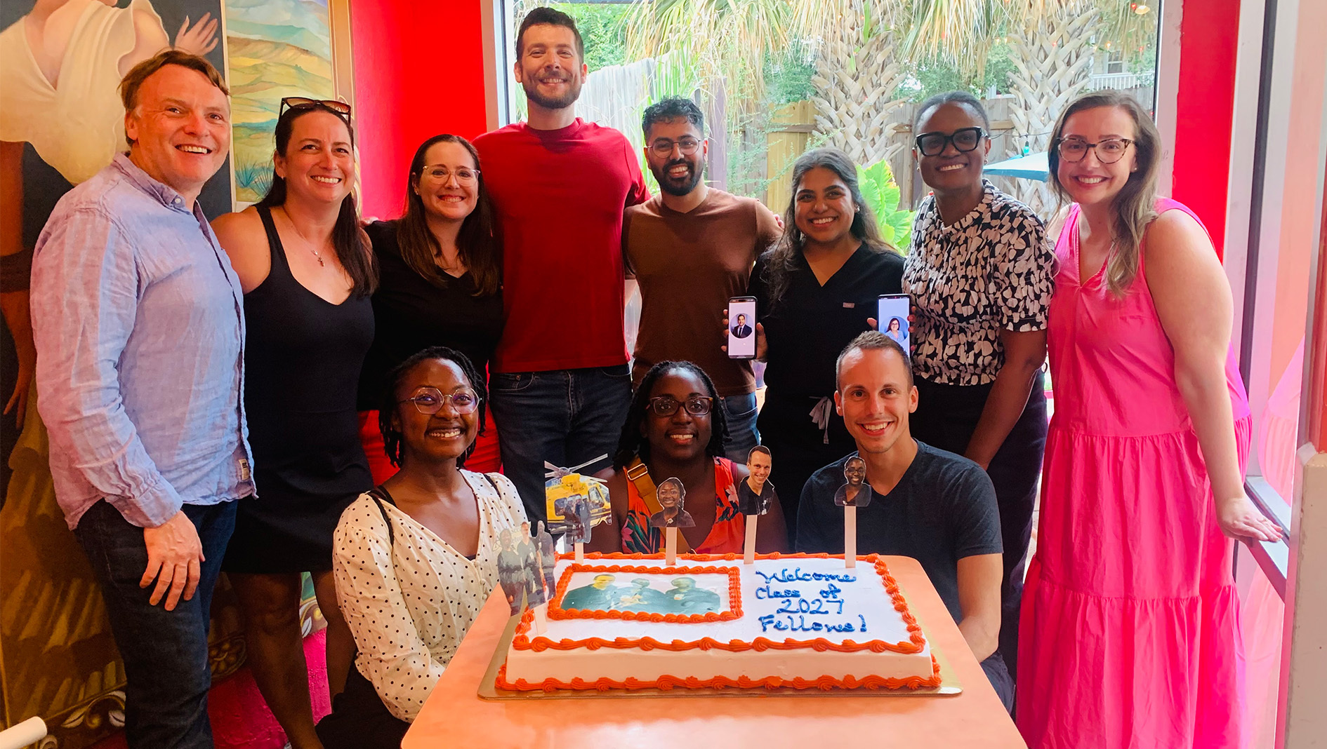 Members of the Neonatal-Perinatal Medicine Fellowship gather around a welcome cake for new trainees.