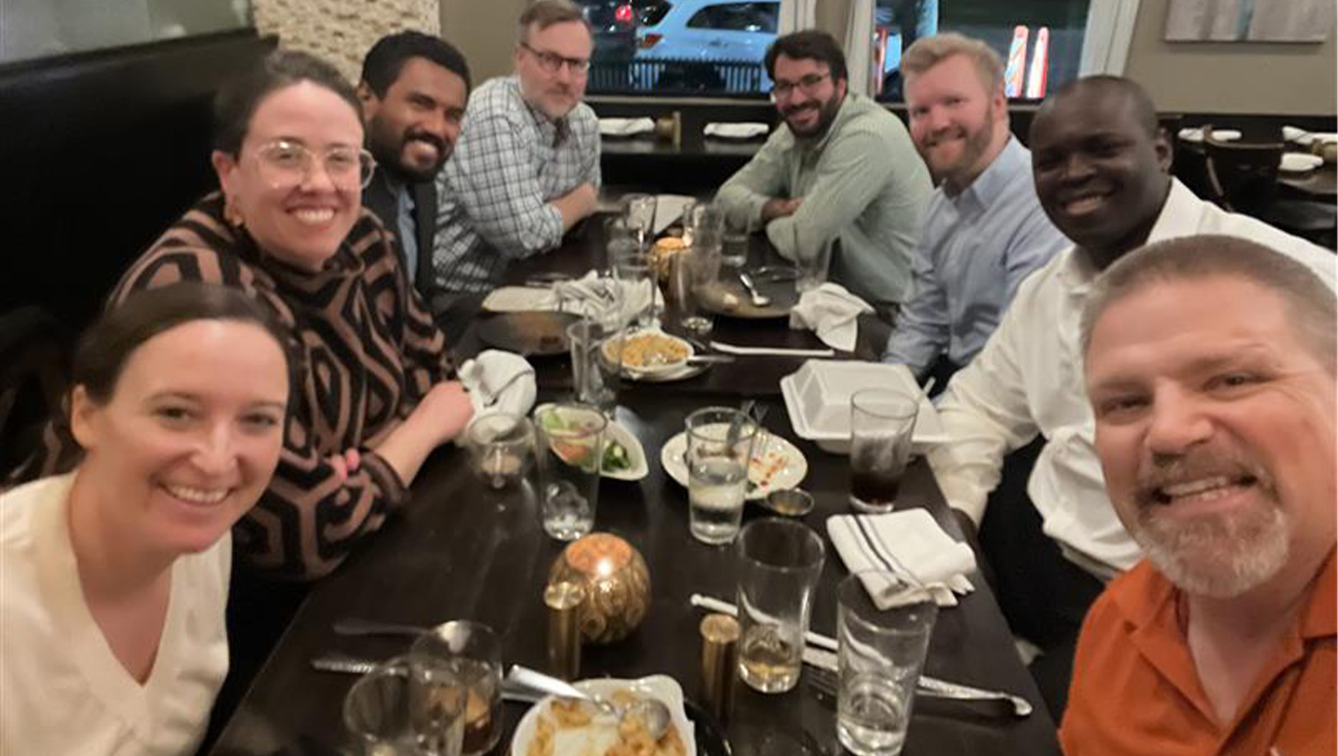 Members of the orthopaedic surgery fellowship pose for a selfie group photo while at dinner.