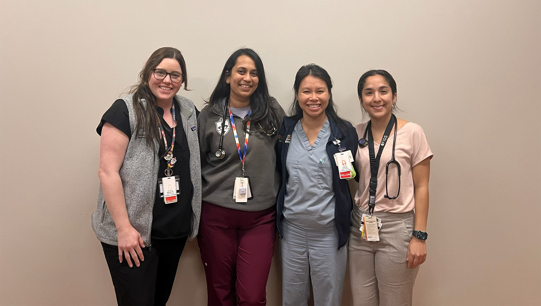 Four women within the Pediatric Hospital Medicine Fellowship stand together for a group photo.