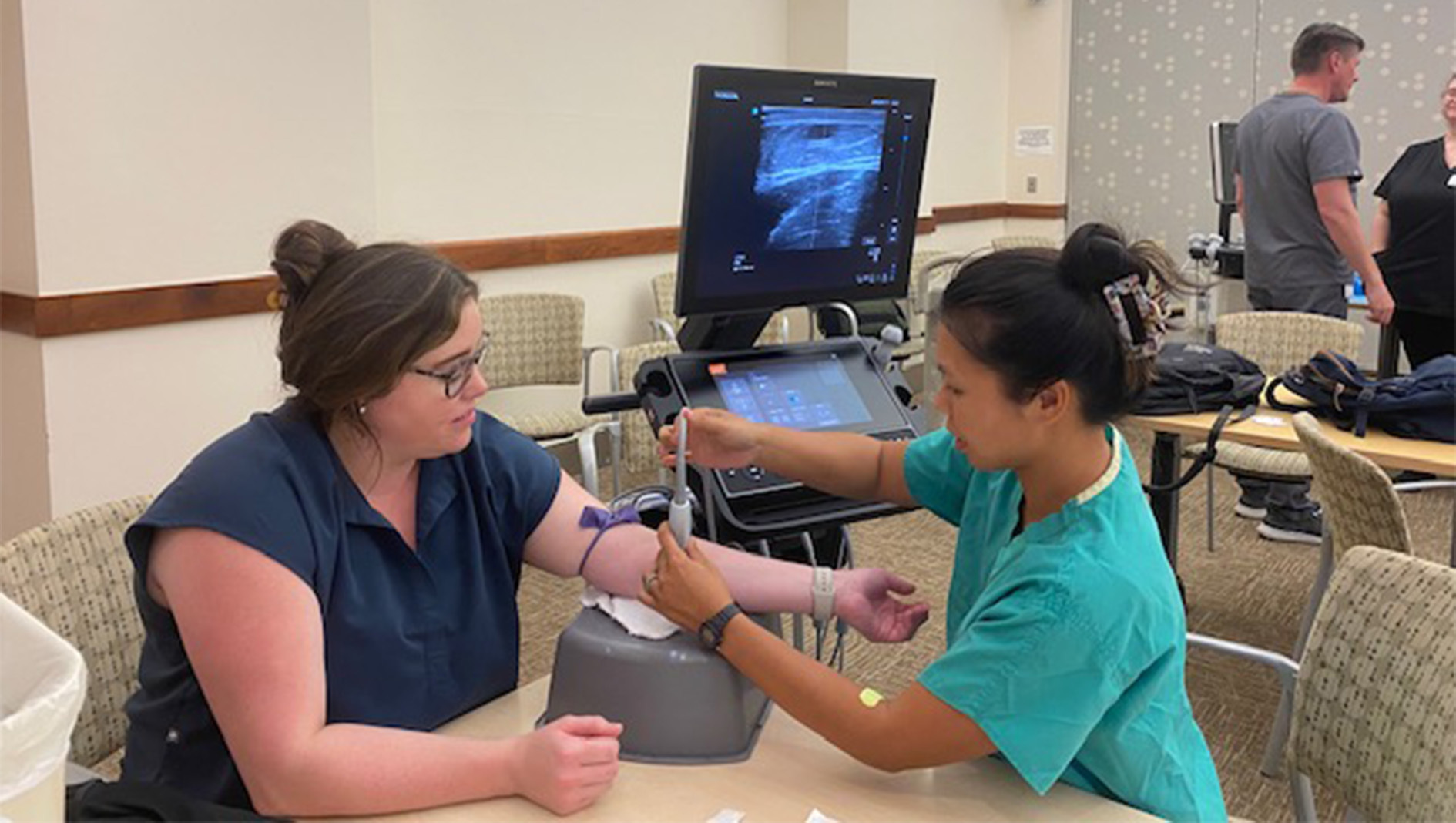 A woman medical trainee performs a medical procedure on a man's arm.