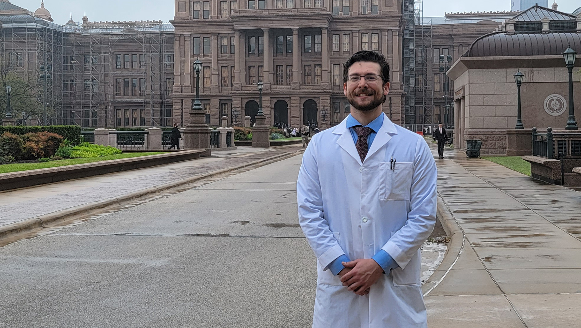 NICU fellow poses in front of Texas State Capitol.