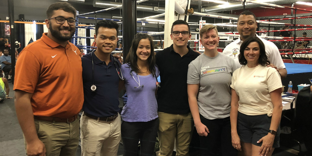 Residents in front of a boxing ring.