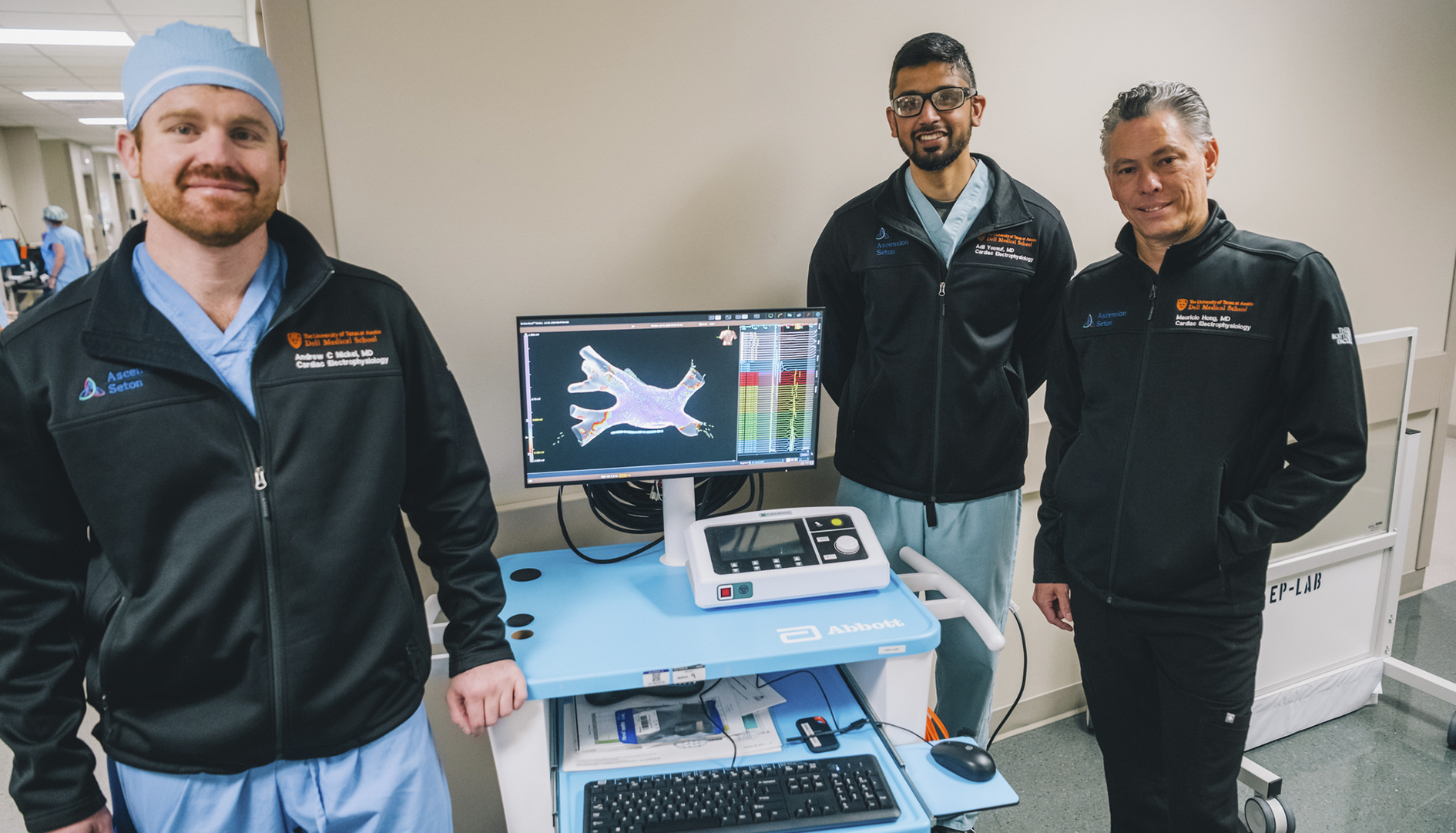 Fellows and faculty review a digital model of blood flowing.
