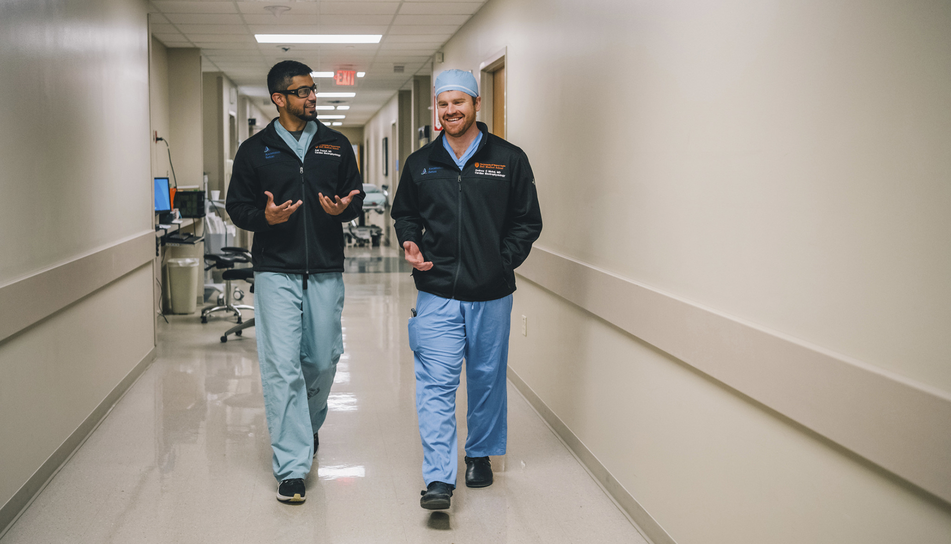 Fellows walk down a hallway.