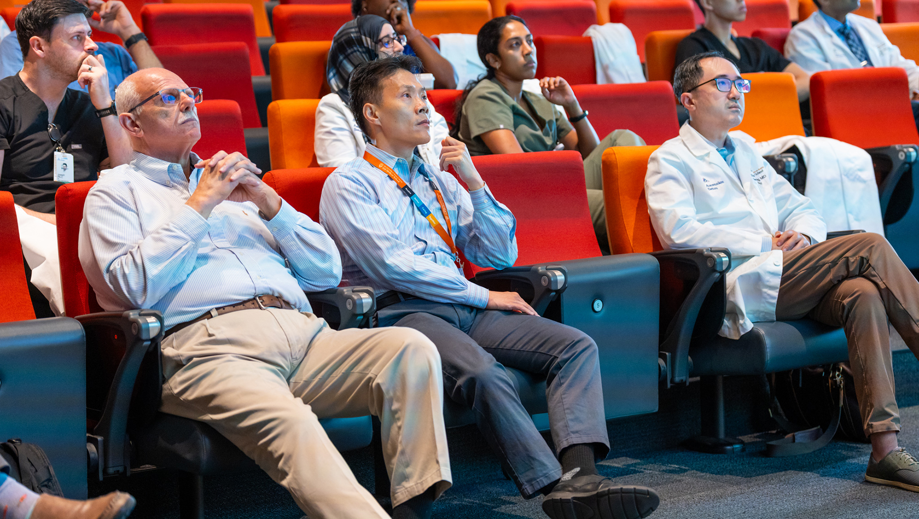 Gastroenterology fellows and faculty listen to a presentation.