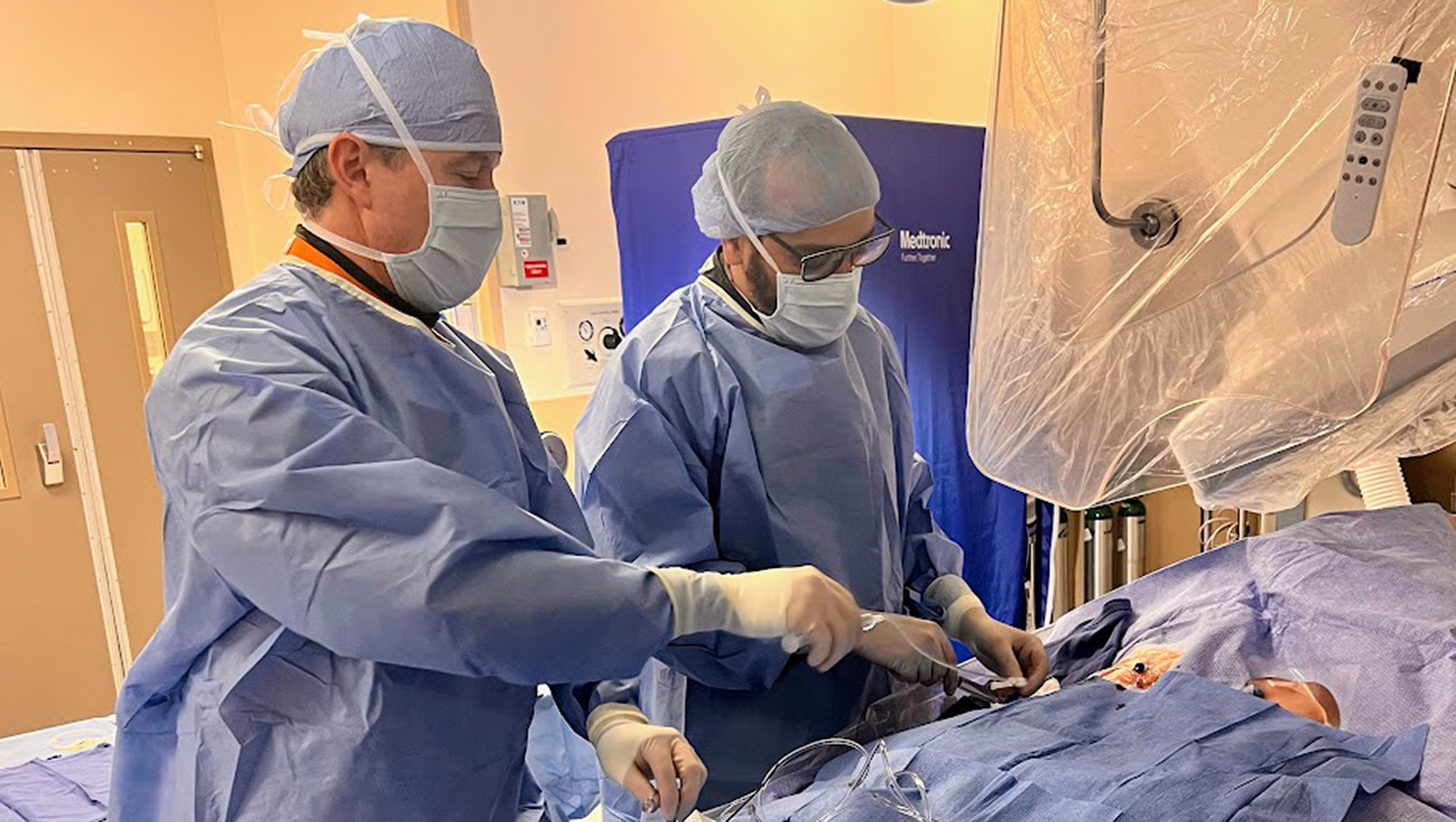 Fellows perform a procedure.