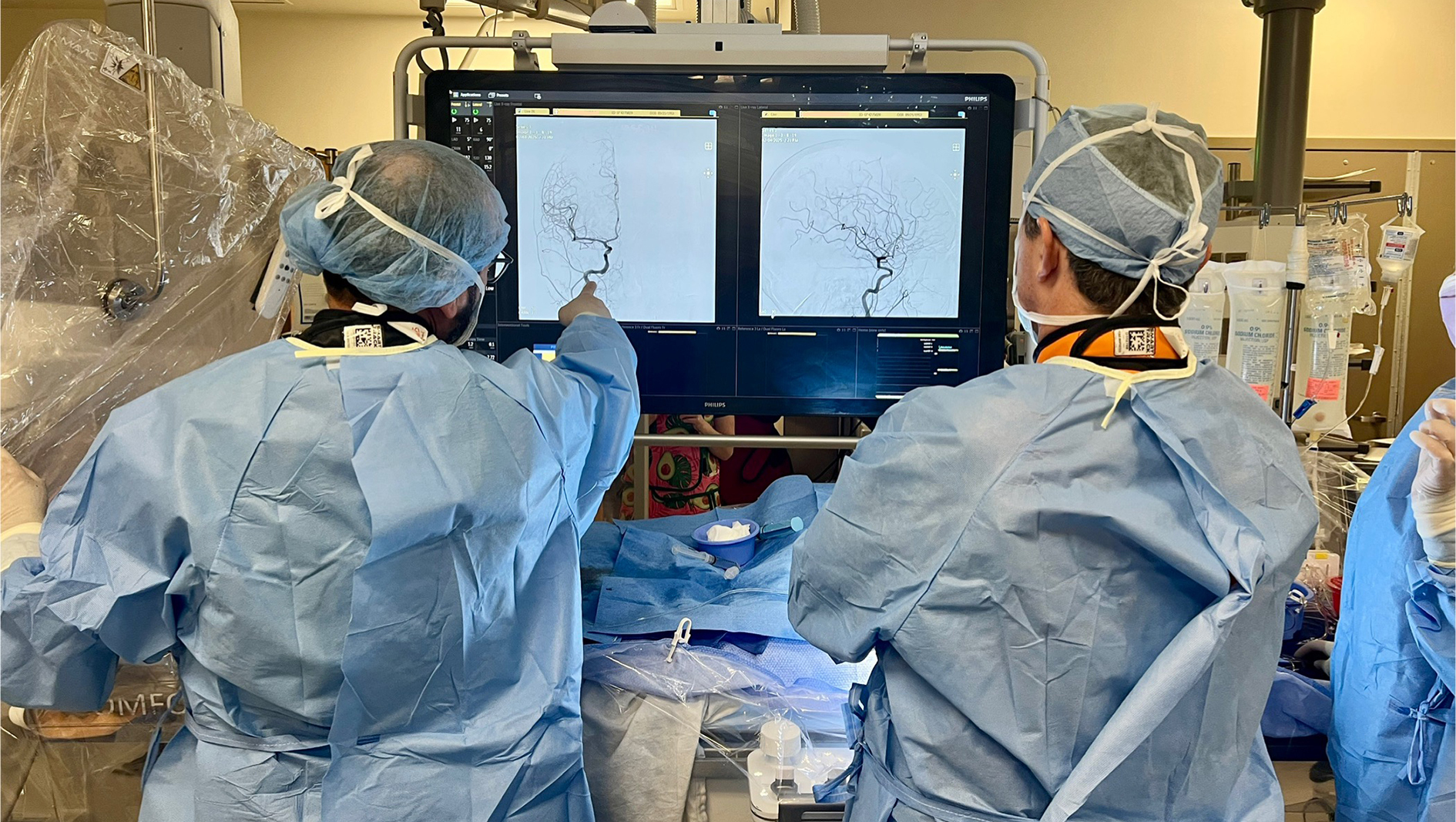 Two fellows review a scan during a procedure.