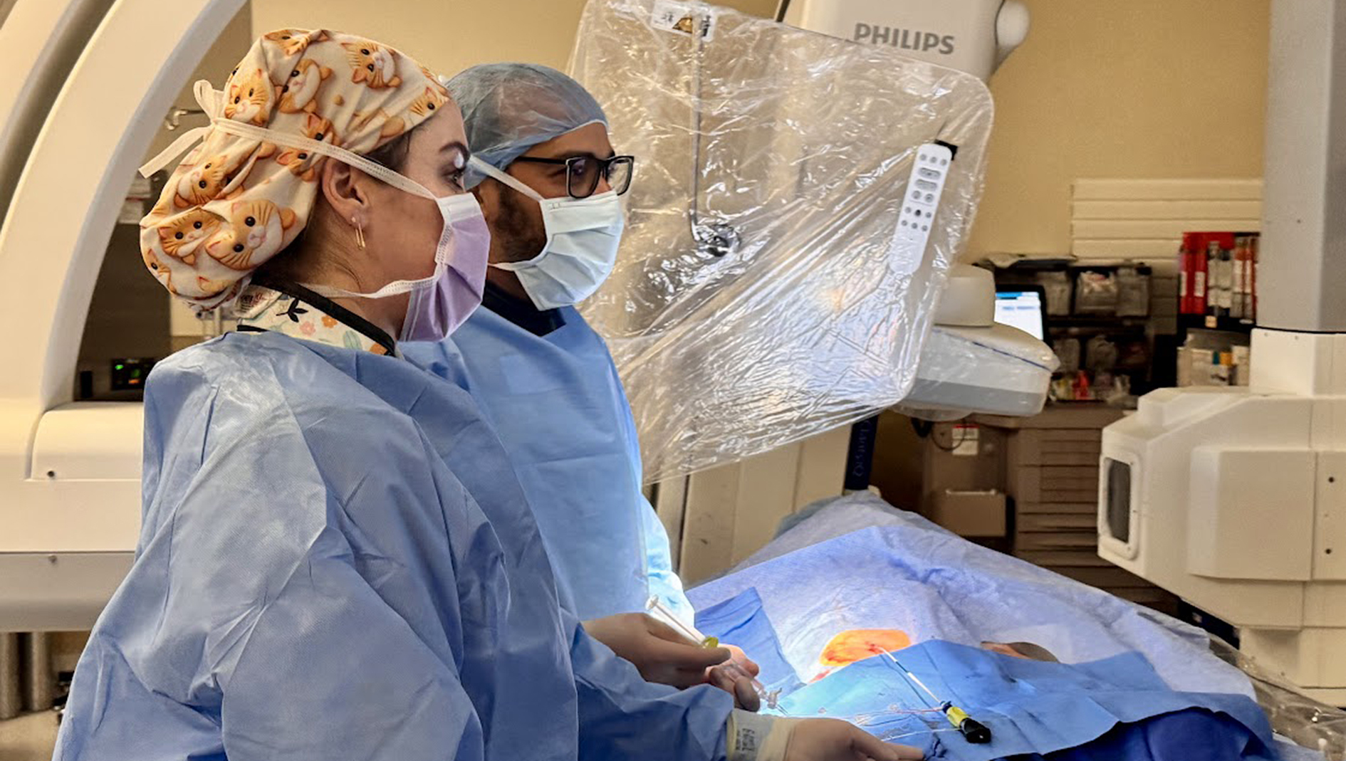 Fellows perform a procedure. 