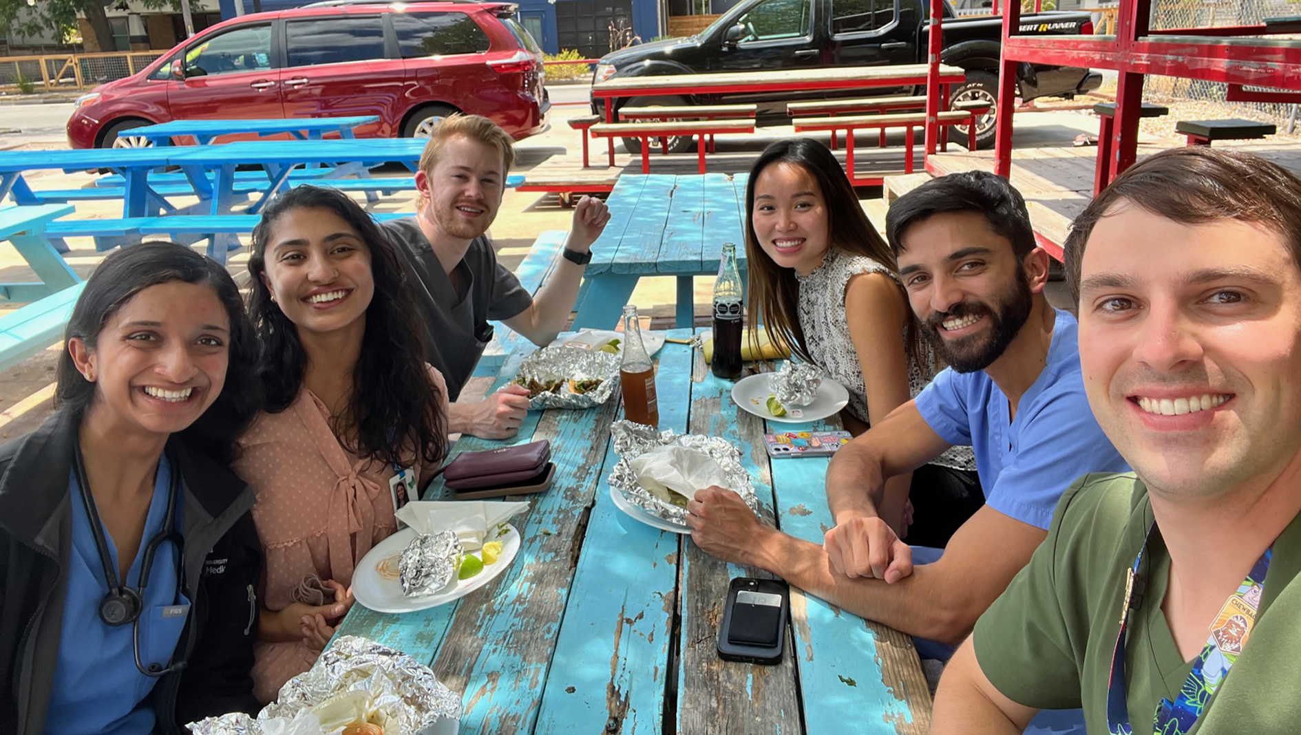 Group photo of pediatric residents eating outside