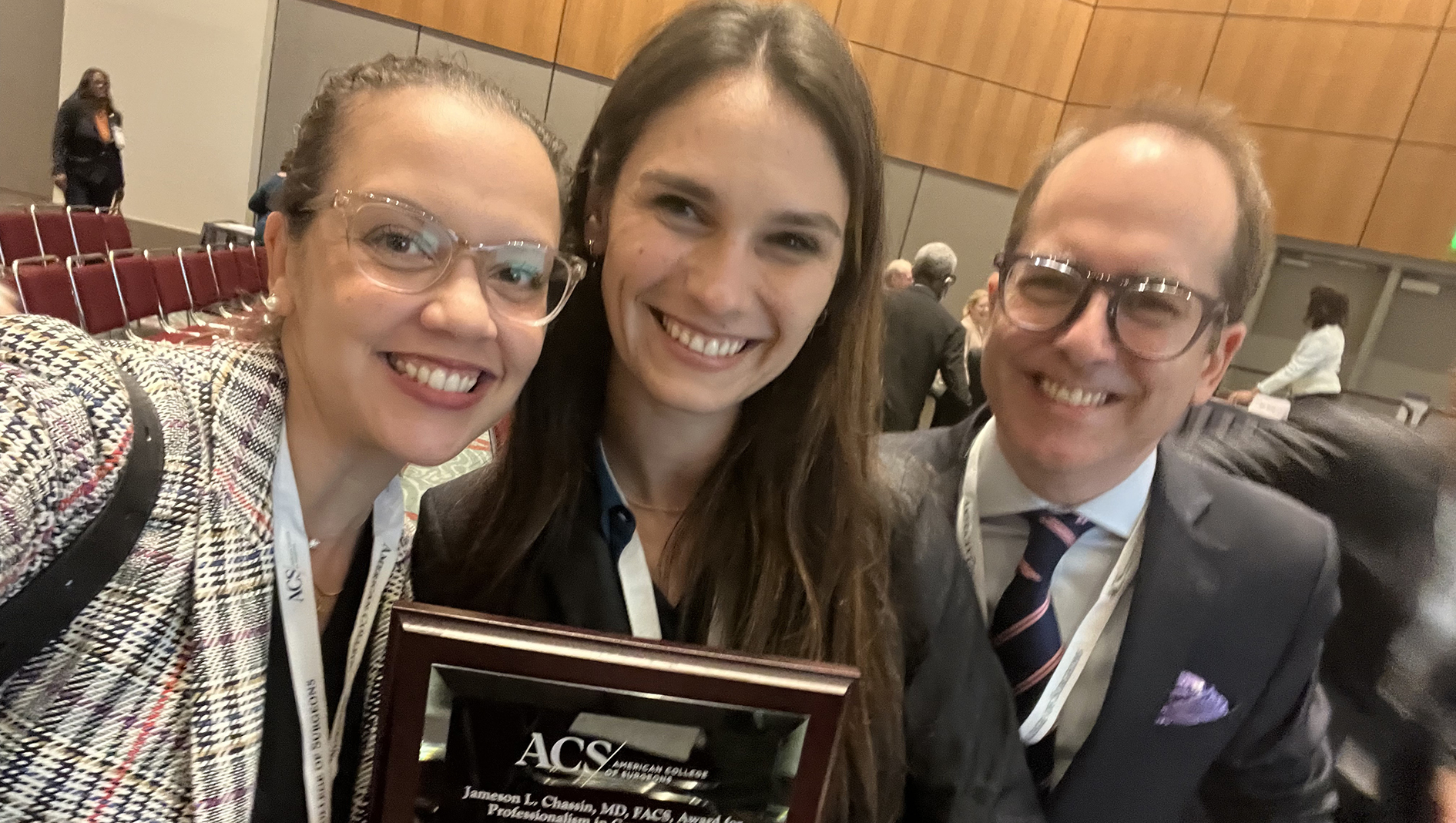 Surgery residents and faculty posing with an award