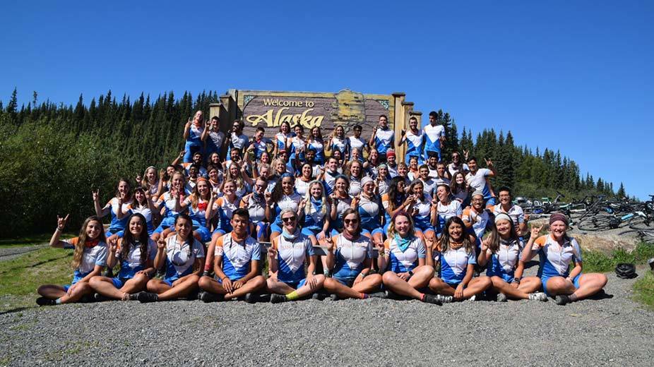 Texas 4000 group in front of an Alaska sign.