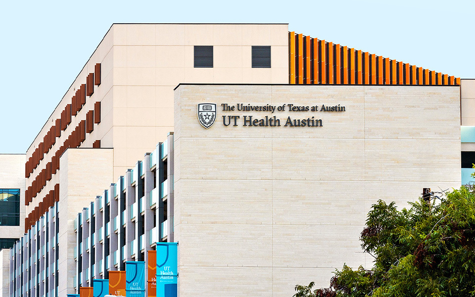 The exterior of Dell Medical School's Health Transformation Building that displays UT Health Austin signage.