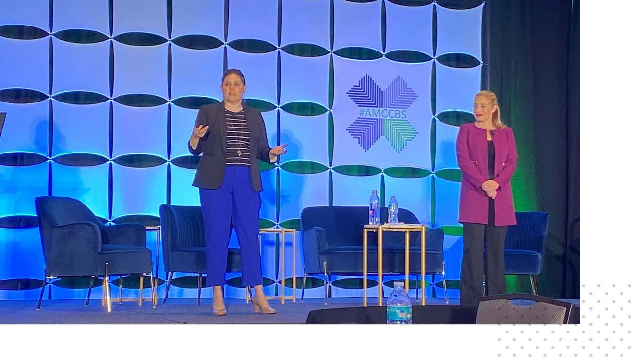 Robin Richardson and Rebekkah Schear on stage at the Association of Community Cancer Centers' Annual Meeting and Cancer Center Business Summit.