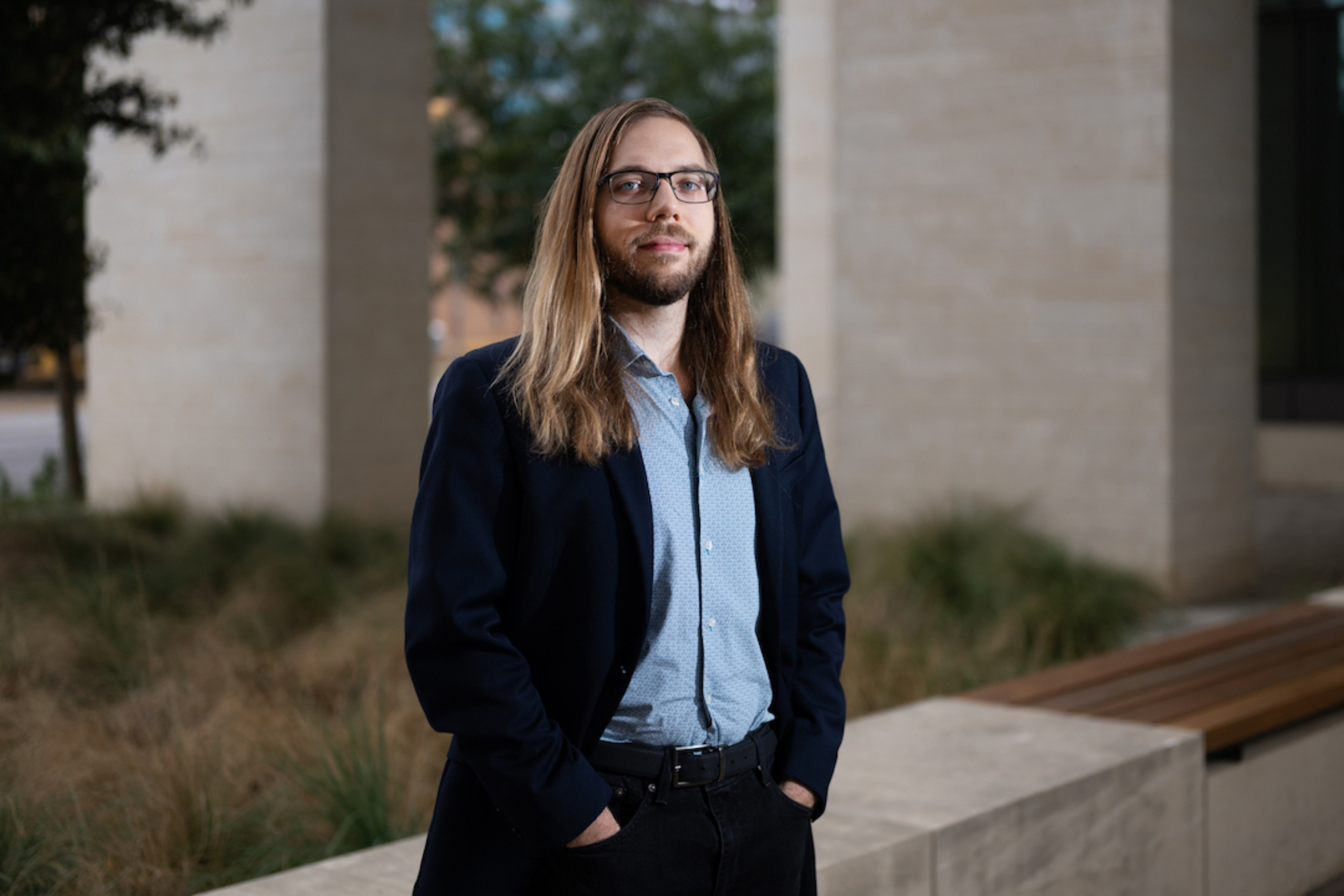 Greg Muller stands with hands in his pockets, looking at the camera.