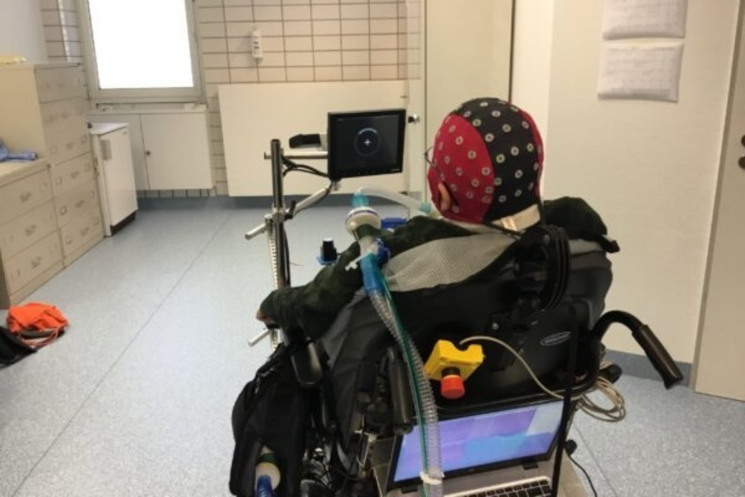 An individual sitting in a brain-powered wheelchair.