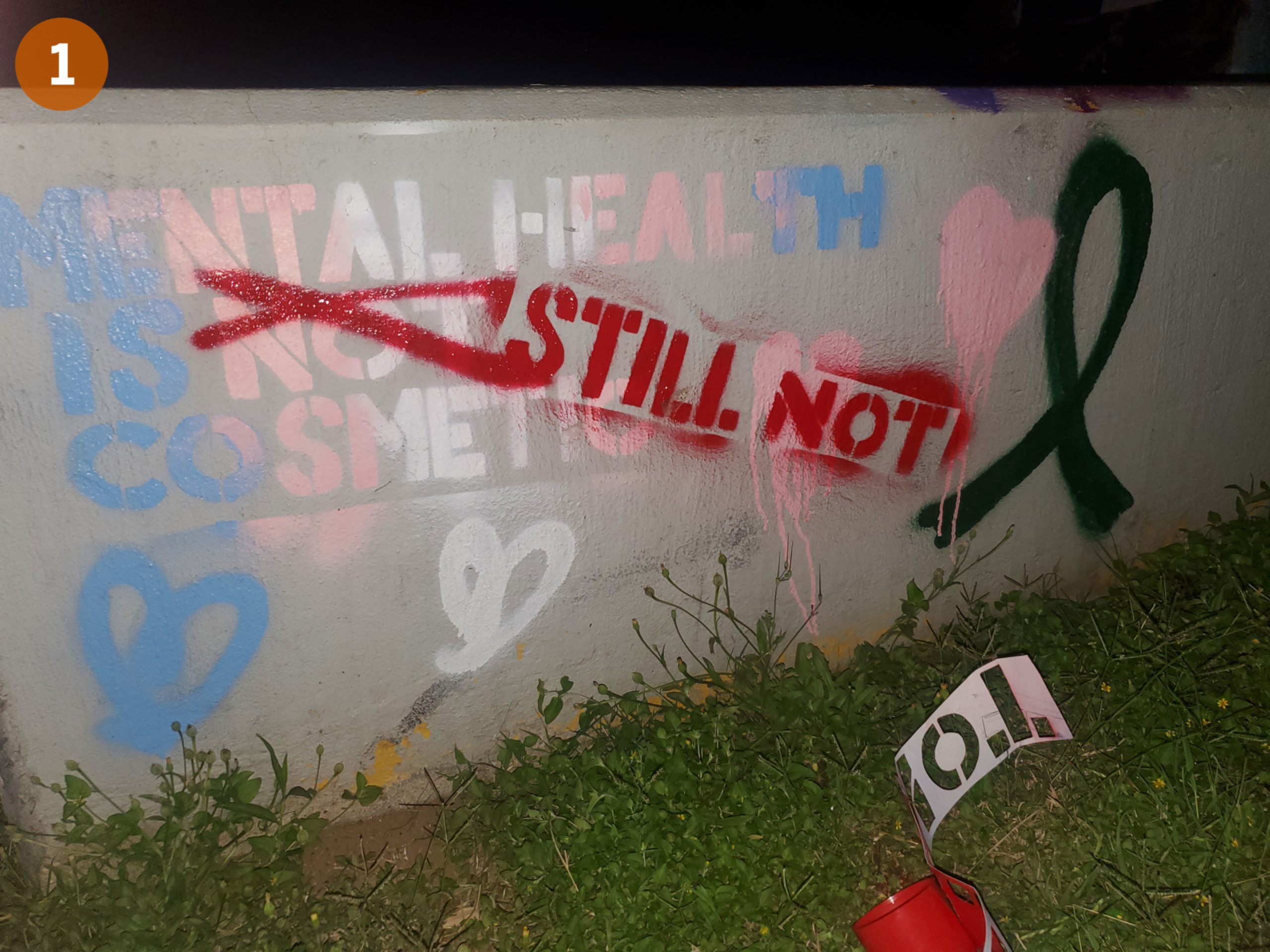 Image 1: Spray chalk artwork stating "Mental health is still not cosmetic."