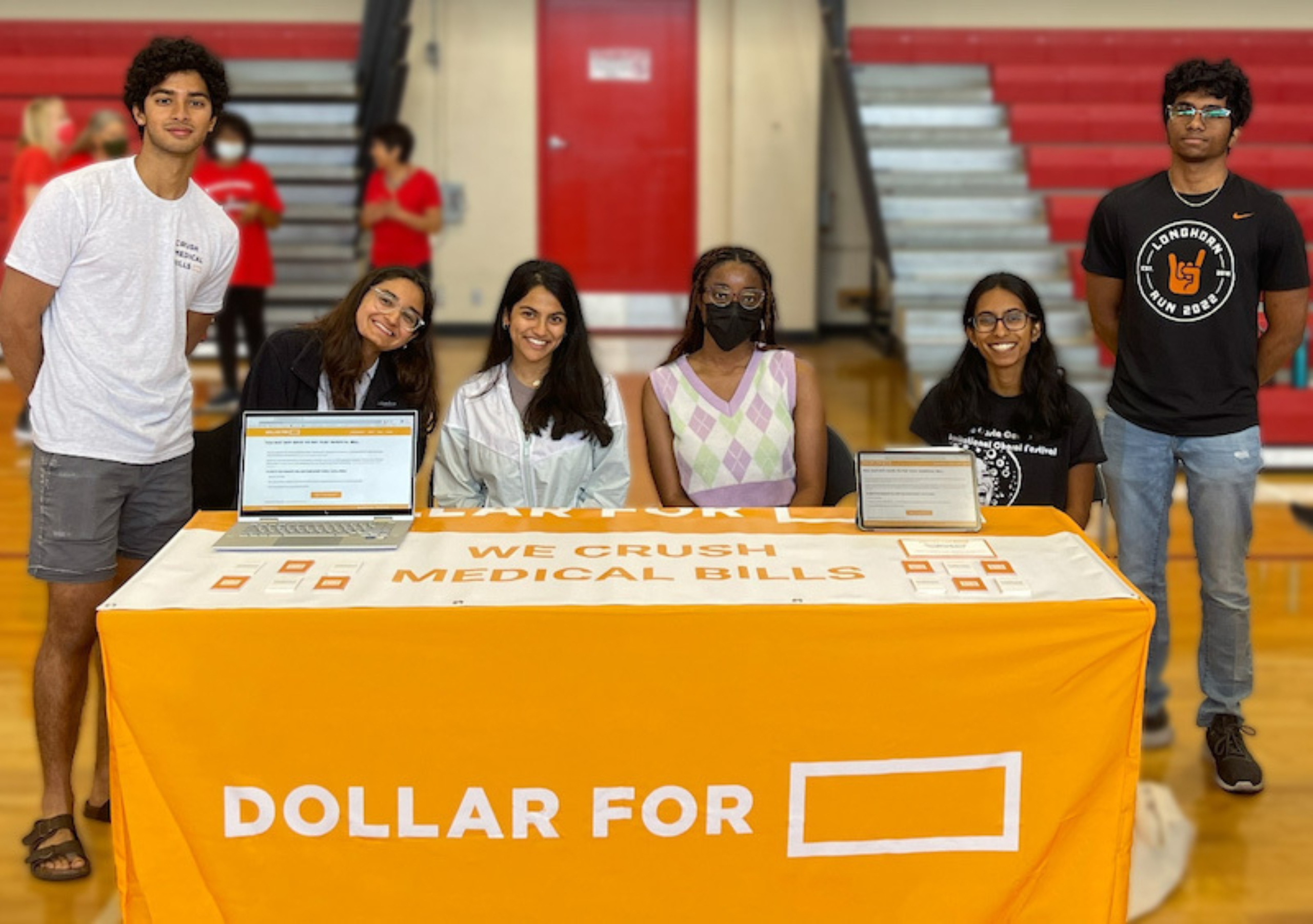 Students from the Central Texas chapter of Dollar For, a national nonprofit, table at a community event.