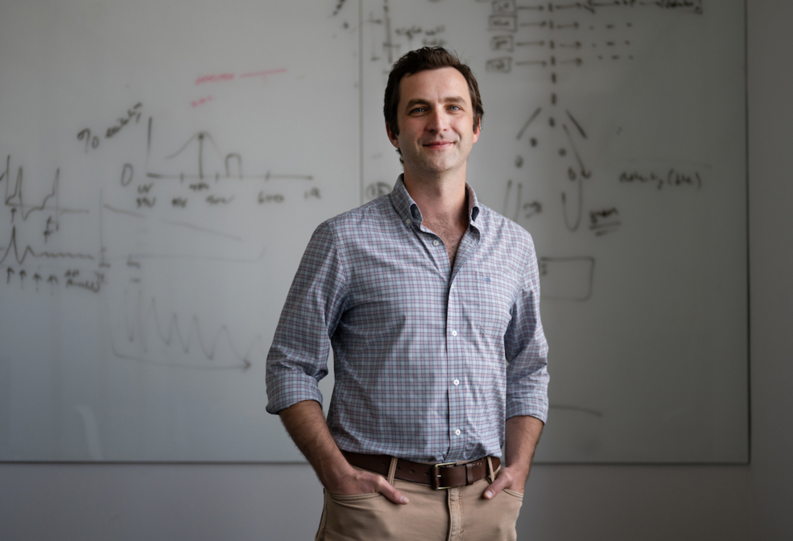 Image: Lief Fenno stands in front of a whiteboard.