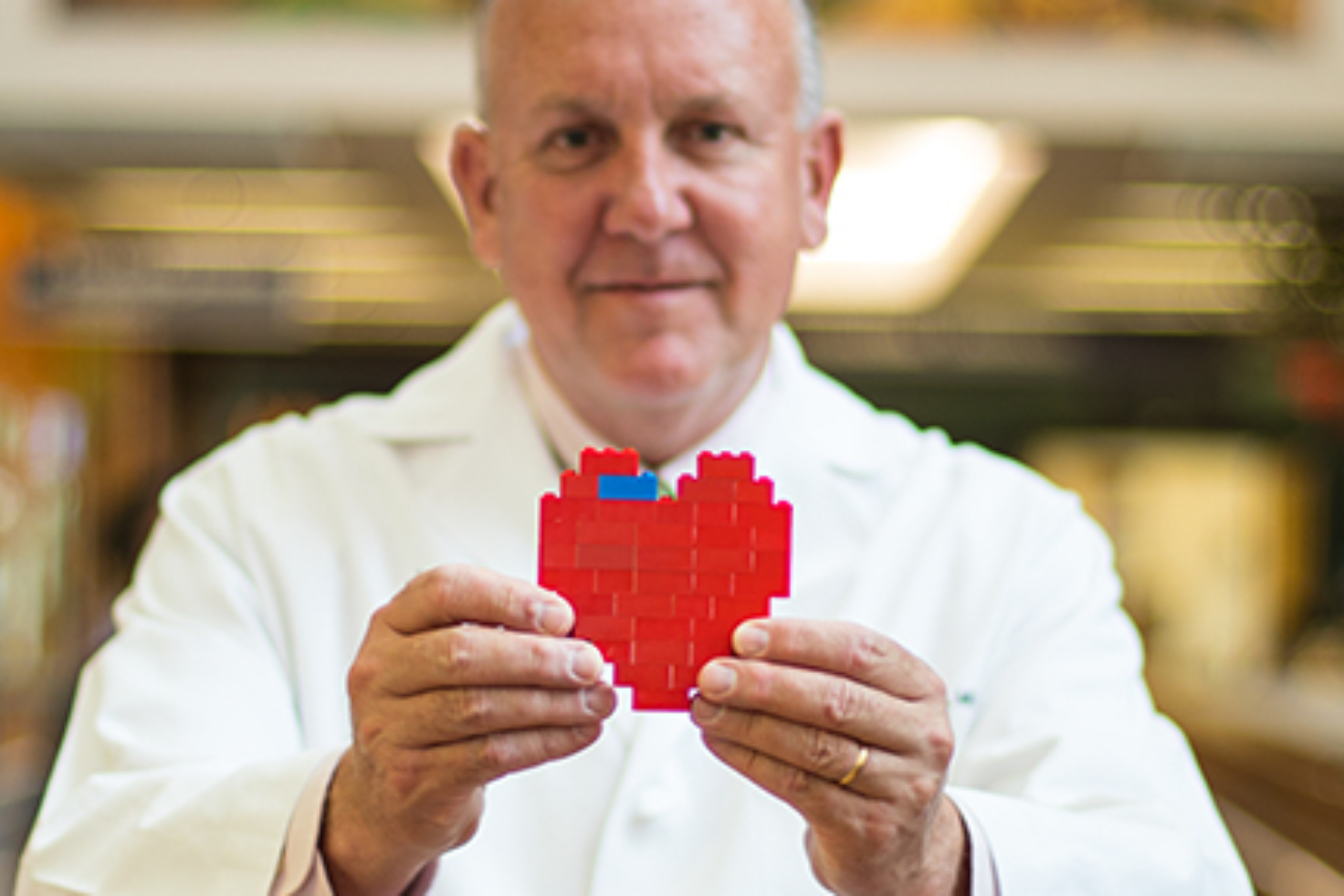 Charles Fraser holding a toy heart.