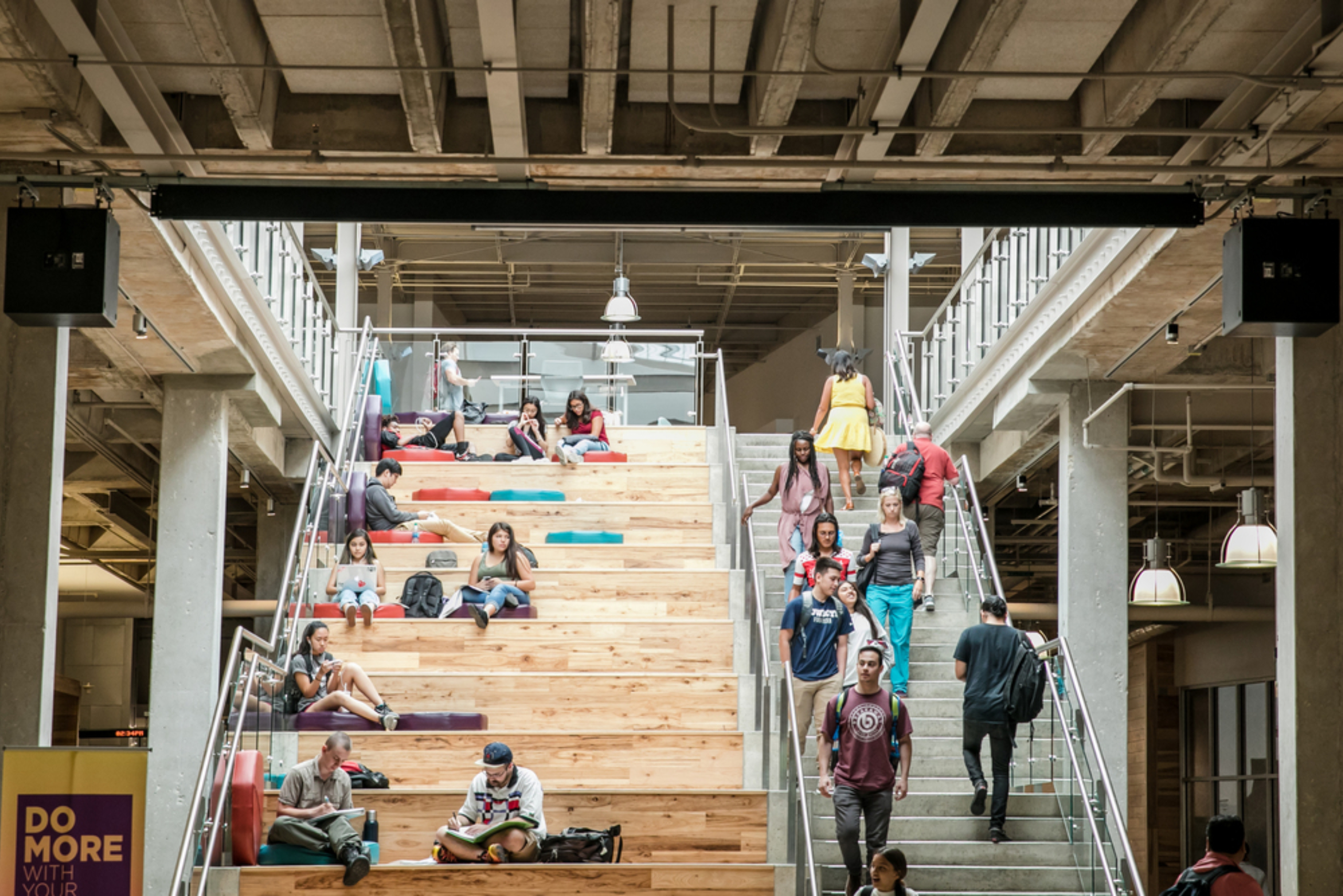 Students standing and sitting on a staircase at an ACC campus.