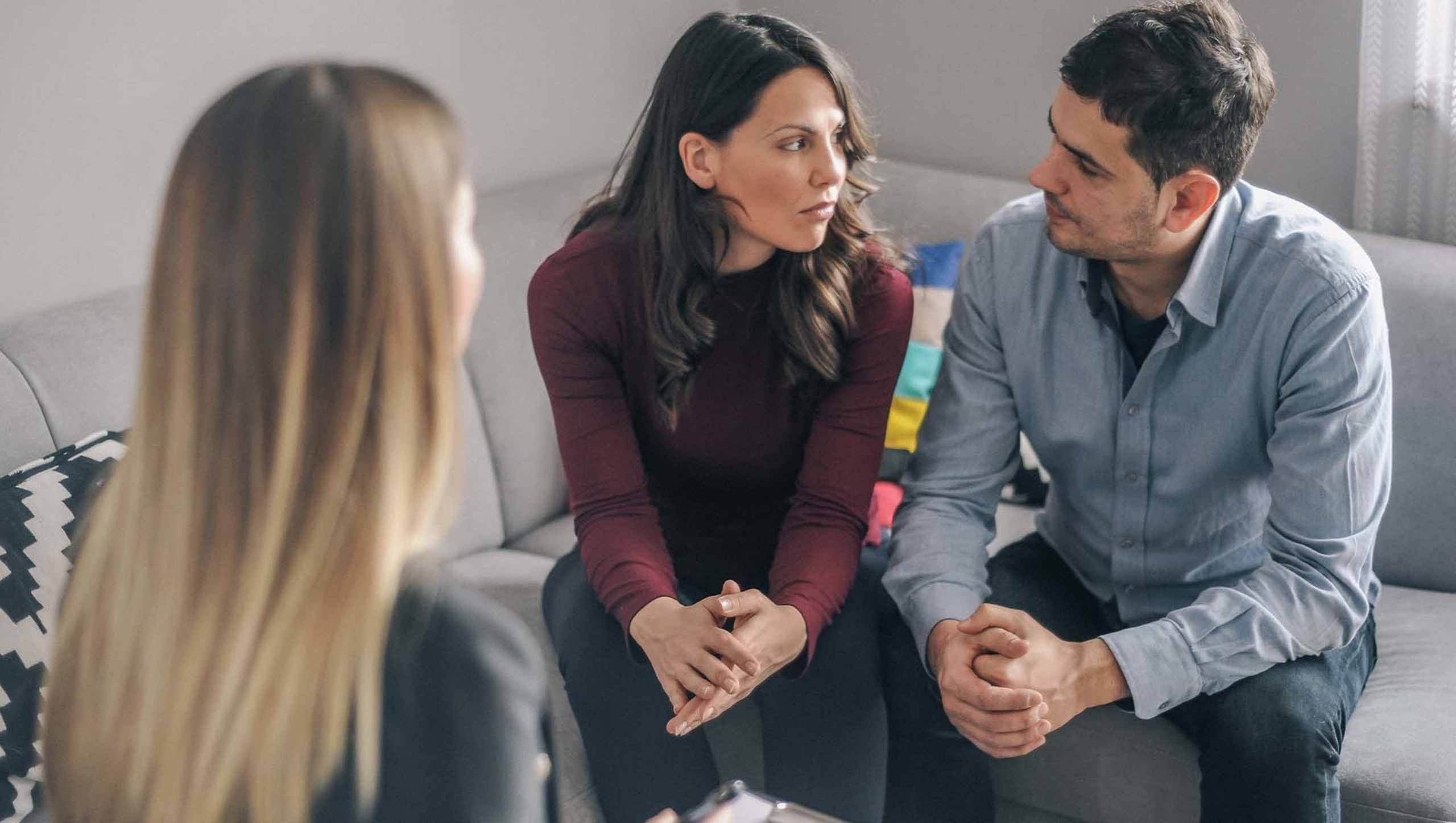 Couple sits together during counseling meeting.