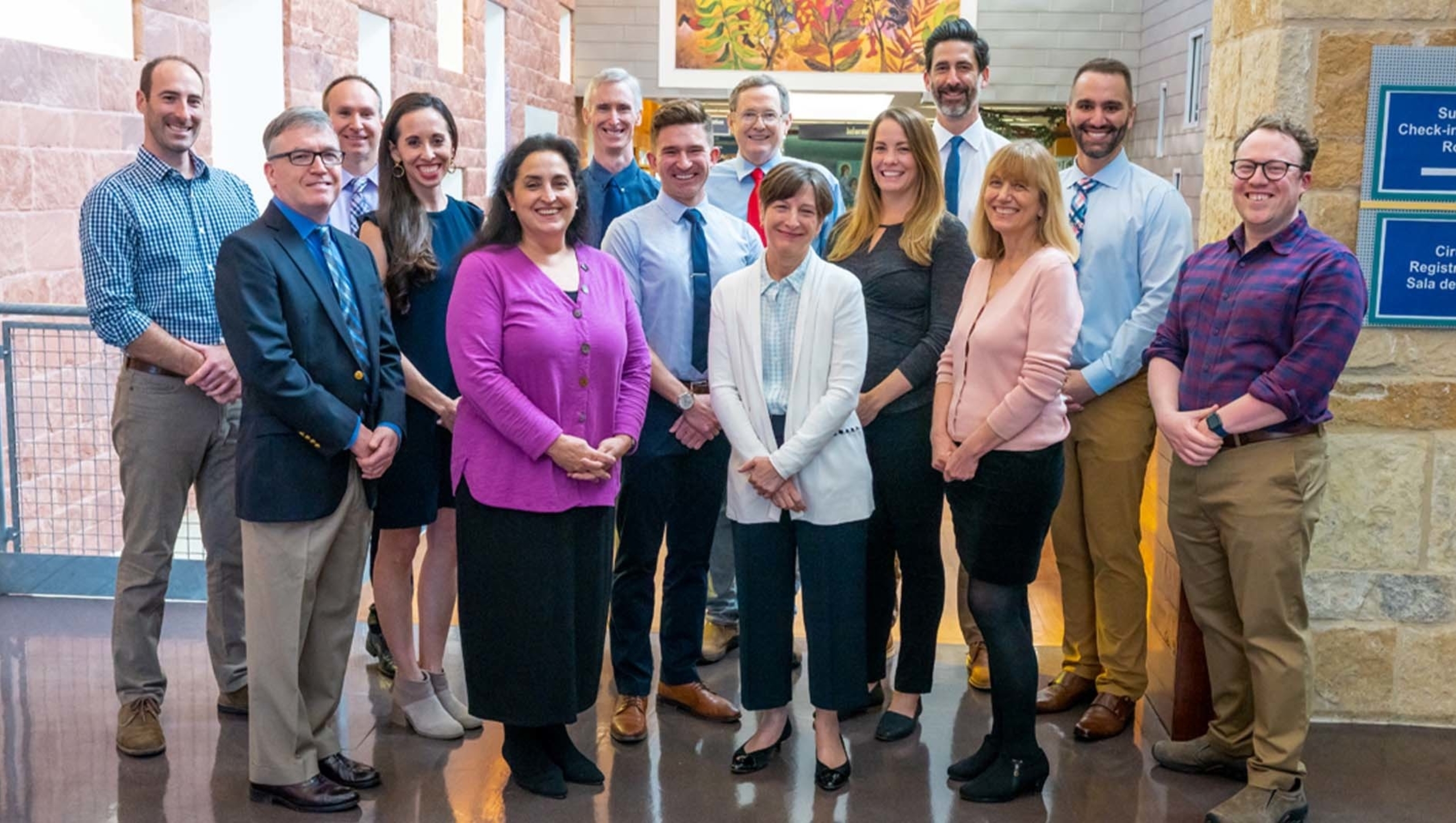 Fourteen members of the Pediatric Critical Care Medicine Fellowship at Dell Medical School pose together in a group portrait.