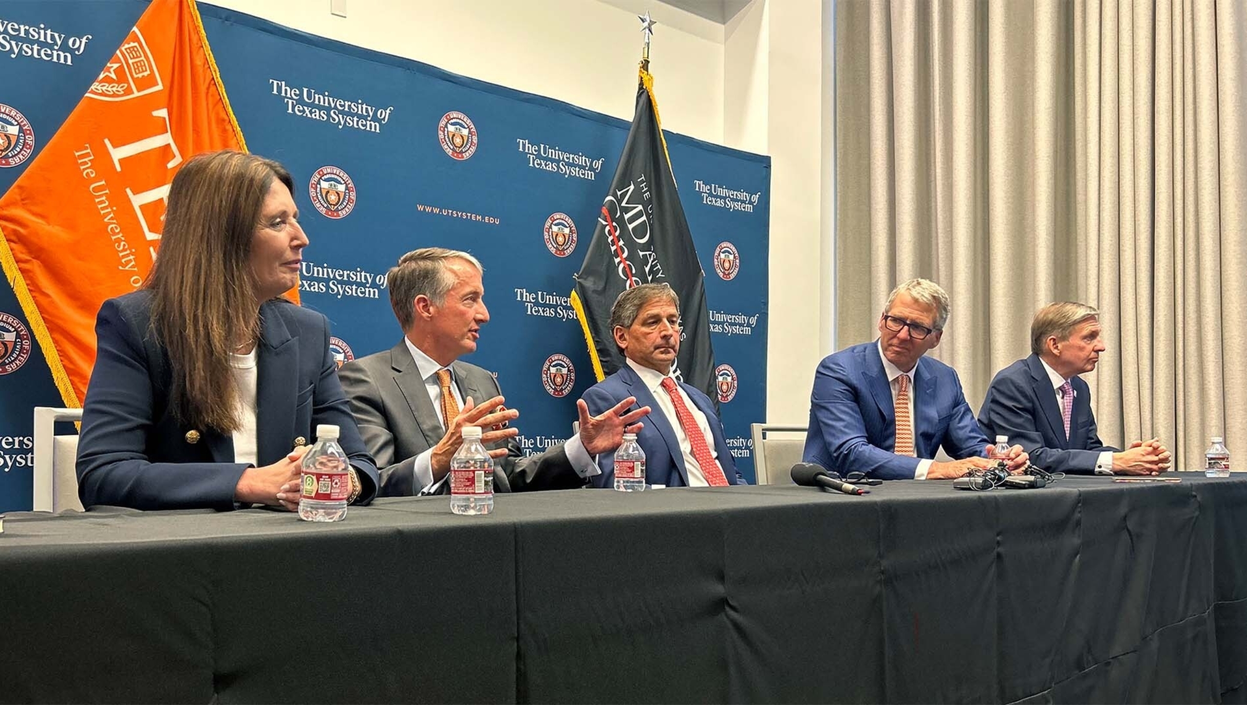From left, the following individuals sit at a table following a press conference announcing a new medical center: Dell Medical School Dean Claudia F. Lucchinetti, UT Austin President Jay Hartzell, UT System Board of Regents Chairman Kevin P. Eltife, UT System Chancellor James B. Milliken, and UT MD Anderson President Peter Pisters.