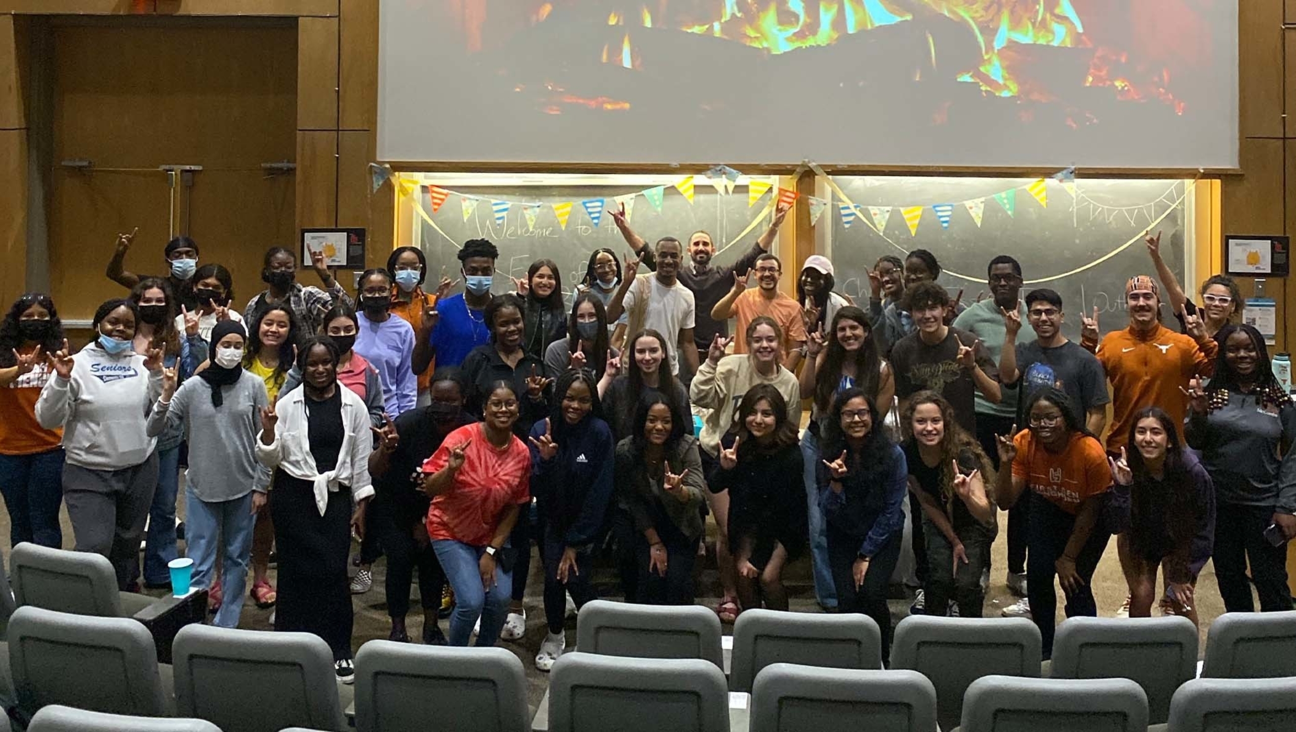 Members of the Summer Chemistry for Pre-Health Professions program posing together in a Dell Med auditorium.