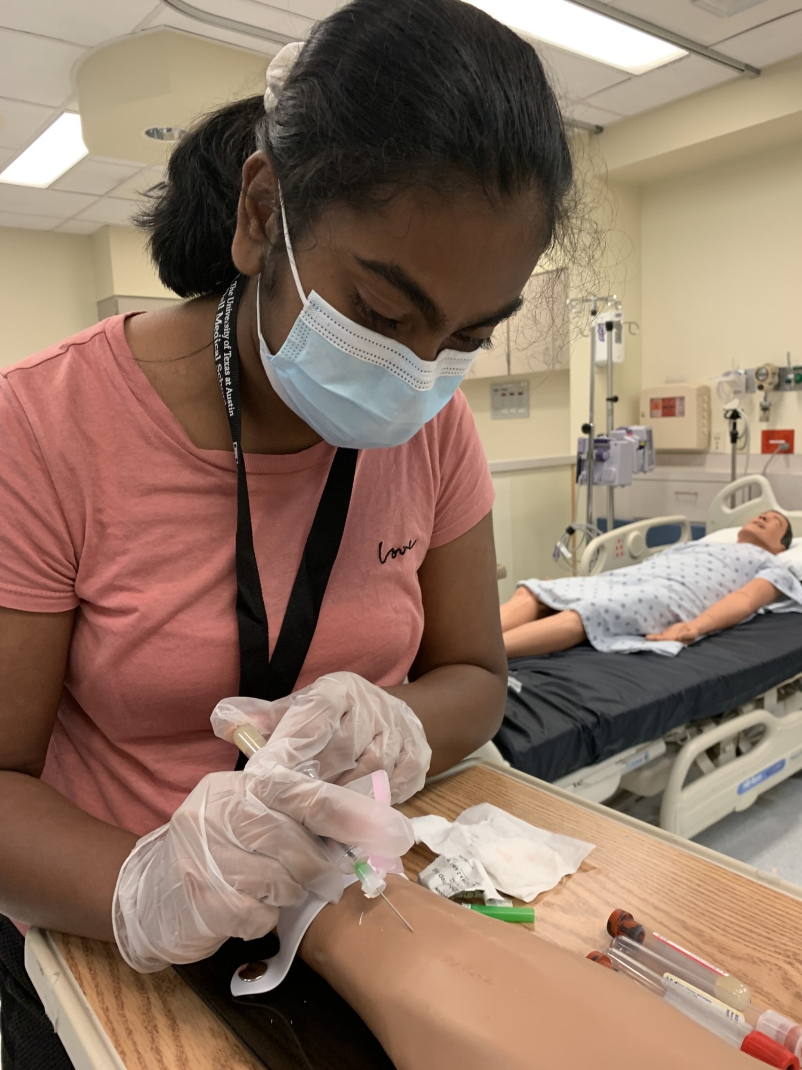 A young adults performs a hands-on medical education activity.