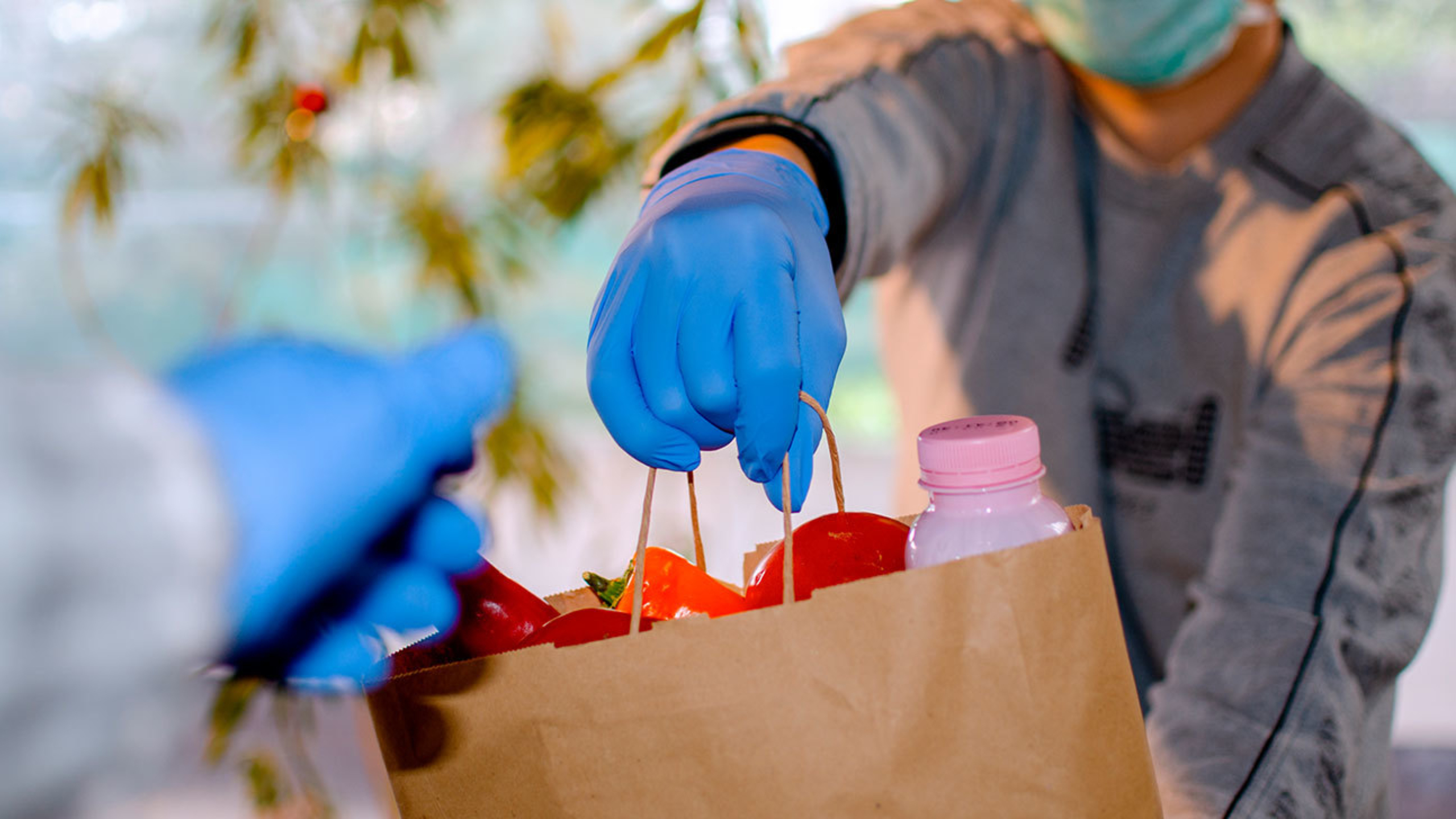 Gloved hands exchanging a parcel.