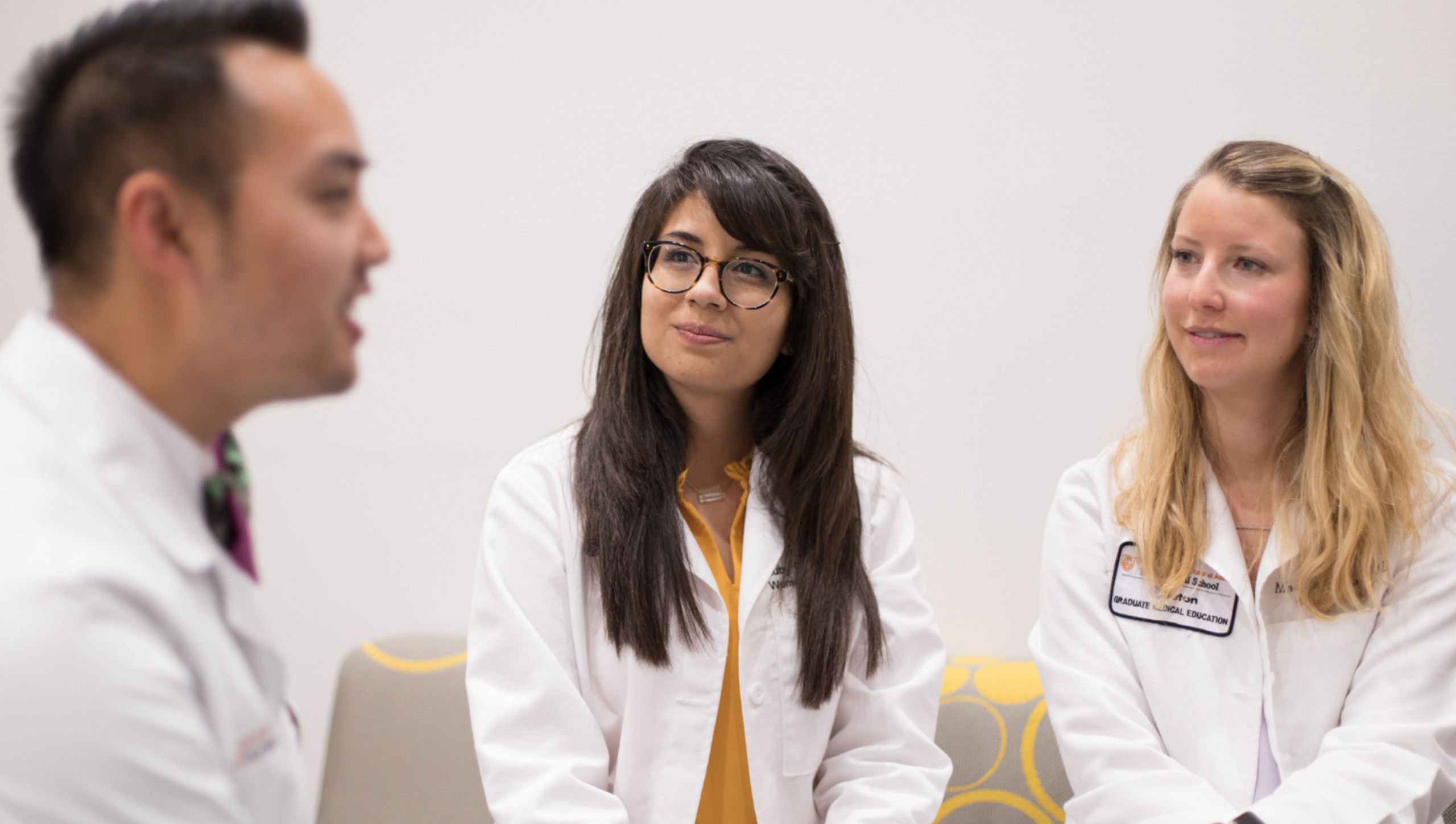 Three residents sit together in a clinical space
