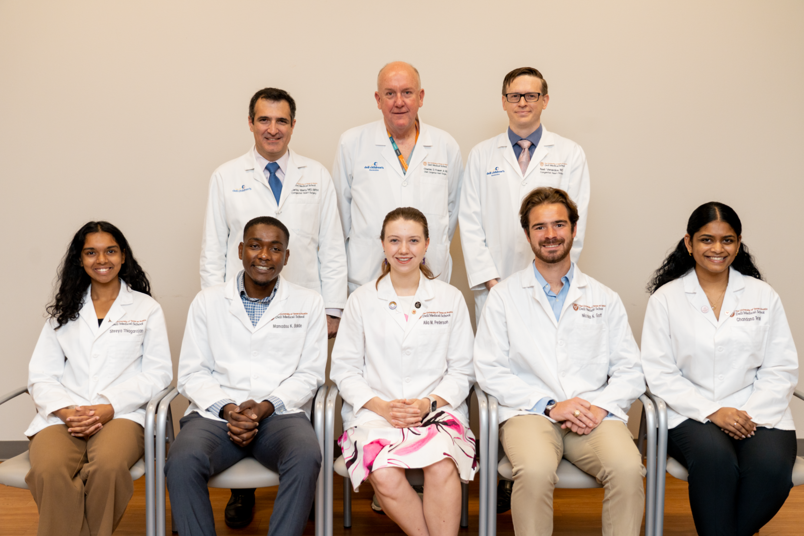 Image with two rows of people, all participants in Dell Med's first-year elective in pediatric congenital heart surgery.