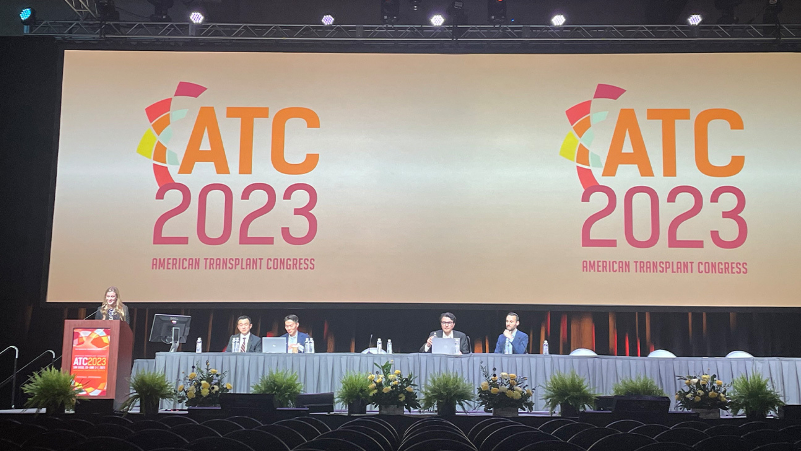 An individual gives remarks at a podium during the 2023 American Transplant Congress.